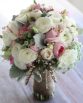GARDEN Bridal Bouquet "Adeline" consisting of roses, ranunculi, lisianthus, Queen Anne's Lace, andromeda and dusty miller. Image by The White Orchid Floral Design.