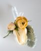 CLASSIC Buttonhole consisting of a rose with ranunculi buds framed with dusty miller.  Image by Alice Healy Photography.