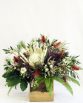 INDUSTRIAL Gold Pot Arrangement consisting of King protea, native flowers, foliages and ferns.  Image by The White Orchid Floral Design.