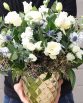 INDUSTRIAL Gold Pot Arrangement consisting of white lisianthus, stocks, roses, spray roses, blue sea holly, blue gum  foliage and ferns.  Image by The White Orchid Floral Design.