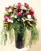 GARDEN Medium Front Facing Feature Arrangement consisting of roses, sweet pea, ranunculi, pom pom chrysanthemums, celosia, pepper berry and magnolia leaf.  Image by The White Orchid Floral Design.
