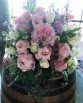 GARDEN Wine Barrel Arrangement consisting of peonies, roses, lisianthus, stocks and pepper berry. Image by The White Orchid Floral Design.