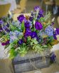 GARDEN Wooden Box Arrangement consisting of lisianthus, hydrangea, succulents, lavender, sea holly, hebe and magnolia leaf.  Image by Panache Photography.